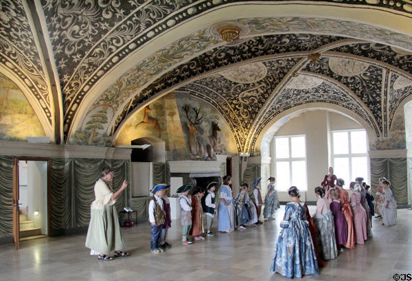 Students practice historic ways in Stag Hall at Gottorf Palace. Schleswig, Germany.