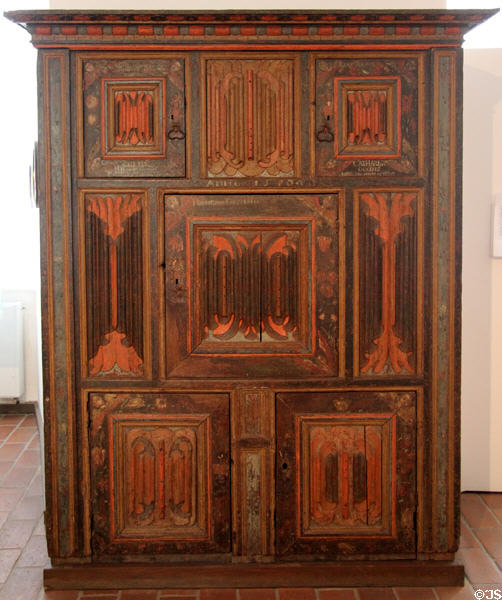 Carved & painted Renaissance-influenced Germanic cupboard (1576) with linen-fold panels at Schleswig Holstein State Museum. Schleswig, Germany.