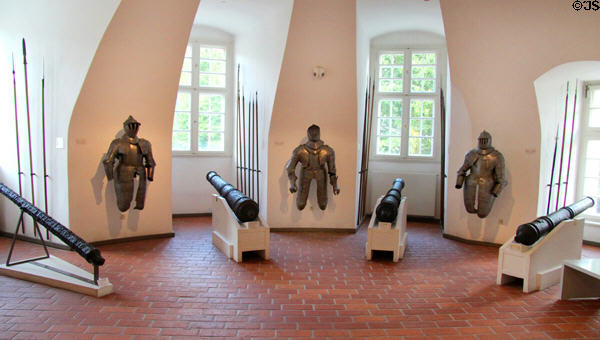 Suits of armor & canons (15th-17thC) in round Butcher's Tower (1540) at Gottorf Palace. Schleswig, Germany.