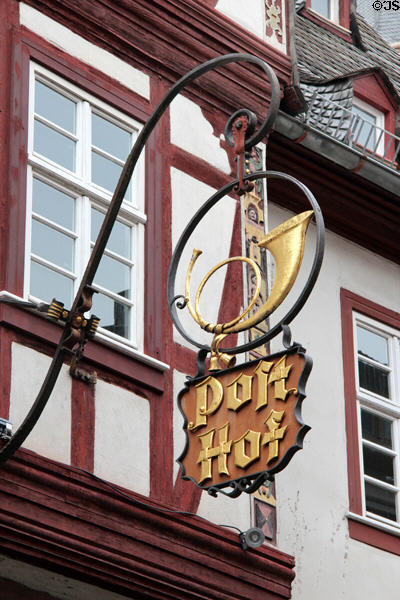 Wrought iron sign with post horn on old post office. Bacharach, Germany.