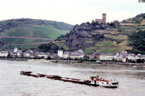 Barge traveling along Rhine River with Gutenfels castle in background. Kaub, Germany.