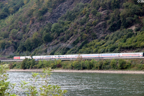 Passenger train traveling along bank of Rhine River. St. Goar, Germany.