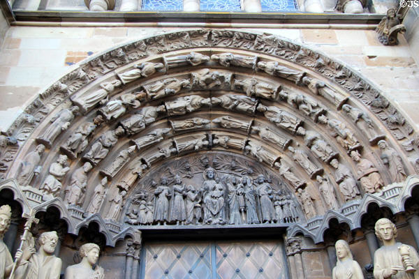 Tympanum with carving of Virgin Mary Enthroned & events of the Nativity over main entrance at Liebfrauenkirche. Trier, Germany.