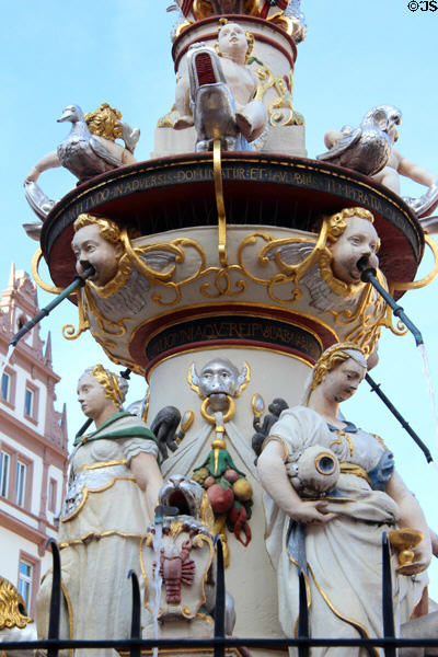 St. Peter's Fountain detail with statues representing cardinal virtues of courage & temperance under geese & putti riding dolphins in Hauptmarkt. Trier, Germany.