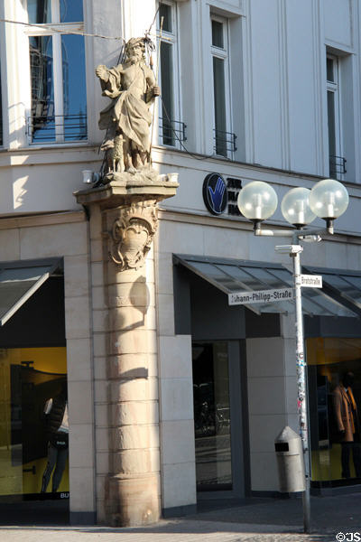 Figure carrying cross & scallop shell, marking pilgrims on road to Santiago de Compostela, on building at Johann-Philippstr. & Brotstr. Trier, Germany.