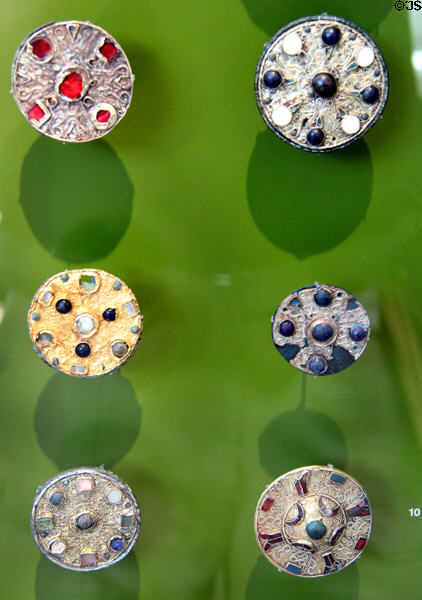 Grave gold disk broaches with glass inlays (7thC) at Trier Archaeological Museum. Trier, Germany.