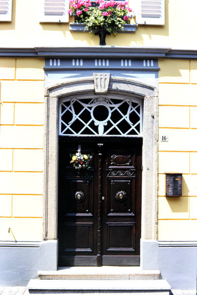 Doorway with flowers and ornate fixtures. Zons, Germany.
