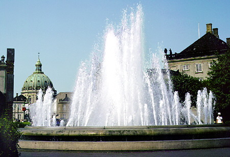 Fountain at the Amalienborg Palace and with domed Marble Church in background, Kobenhavn. Denmark.