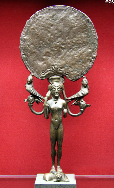Metal standing mirror in form of Aphrodite with sirens & bird-like creatures (c540 BCE) from Laconia, Greece at Antikensammlungen. Munich, Germany.