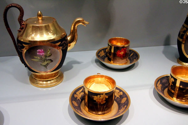 Porcelain tea service painted with flowers on black by Dagoty of Paris (c1810) & Nymphenburg (c1815) copies at Bavarian National Museum. Munich, Germany.