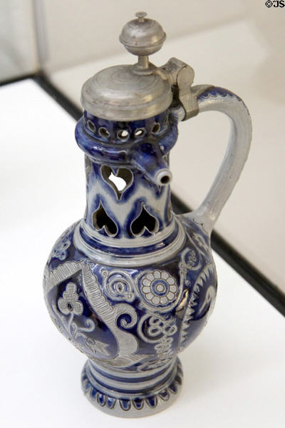 Stoneware covered cobalt blue painted puzzle jug (c1700) from Westerwald at Bavarian National Museum. Munich, Germany.