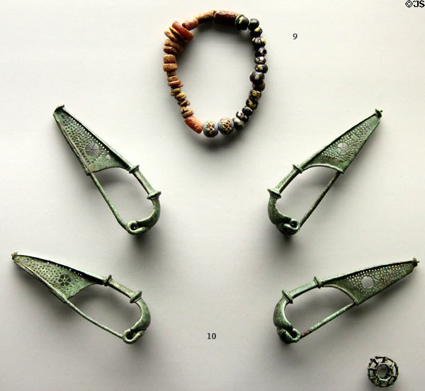 Roman-era beaded bracelet plus bronze sprung fasteners (Fibeln) found near Heimstetten at Bavarian State Archaeological Collection. Munich, Germany.