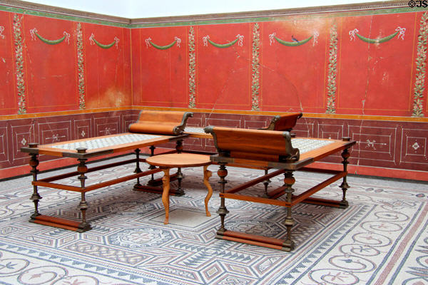 Dining room of Roman villa with original mosaic floor (early 3rdC), reconstruction of wall mural & furniture with new wooden parts held by bronze joinery (80 BCE) at Bavarian State Archaeological Collection. Munich, Germany.