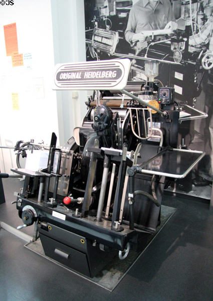 Heidelberg Platen printing press (1970 first produced 1914) was first automatic machine to insert paper, print, then pile output with grippers at rate of 5500 sheets / hour at Deutsches Museum. Munich, Germany.