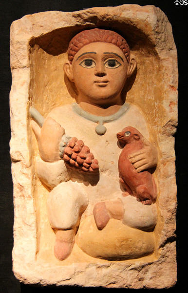 Coptic tomb stela for boy with grapes & dog of limestone (4thC CE) from Antinoopolis at Museum Ägyptischer Kunst. Munich, Germany.