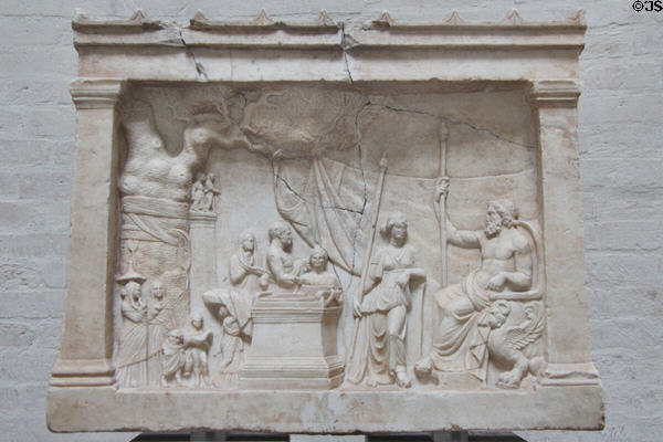 Munich Votive Relief (c200 BCE) from Greece shows family approaching Asclepius, god of healing, & his daughter Hygeia at Glyptothek. Munich, Germany.