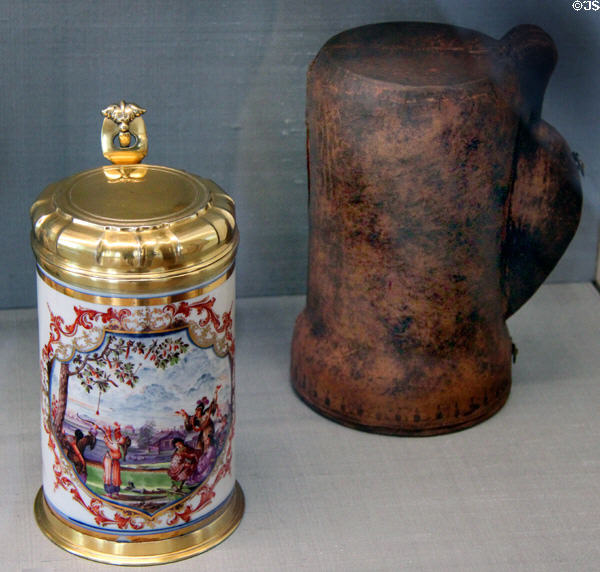 Meissen porcelain chinoiserie mug (krug) with gilded parts & leather case (c1723-4) by Johann Gregorius Höroldt at Meissen porcelain museum at Lustheim Palace. Munich, Germany.