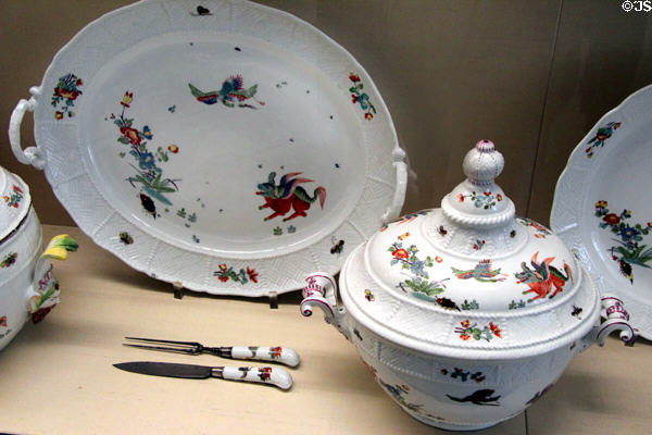 Several serving pieces of Meissen porcelain painted with crane flying above kylin beast of Chinese mythology (c1740) at Meissen porcelain museum at Lustheim Palace. Munich, Germany.