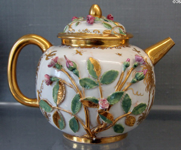 Meissen porcelain teapot with applied rose branches painted in gold & enamel colors at Meissen porcelain museum at Lustheim Palace. Munich, Germany.