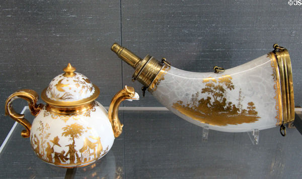 Meissen porcelain teapot with eagle spout plus powder horn both gilded with Chinese scenes at Meissen porcelain museum at Lustheim Palace. Munich, Germany.