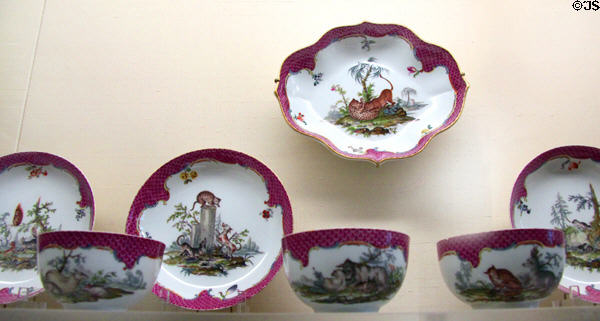 Meissen porcelain service painted with animals framed with rococo purple mosaic scale decoration (c1750-60s) at Meissen porcelain museum at Lustheim Palace. Munich, Germany.