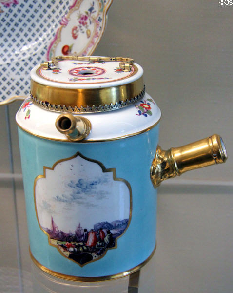 Meissen porcelain turquoise chocolate pot (mid 1700s) with Asian scenes painted in white quatrefoil at Meissen porcelain museum at Lustheim Palace. Munich, Germany.