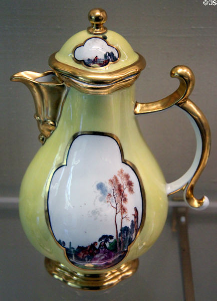 Meissen porcelain yellow coffee pot (c1740-5) painted with Watteau-figures at Meissen porcelain museum at Lustheim Palace. Munich, Germany.
