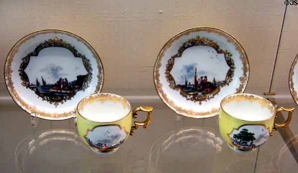 Meissen porcelain yellow cups & saucers (c1743) painted with Dutch landscapes at Meissen porcelain museum at Lustheim Palace. Munich, Germany.