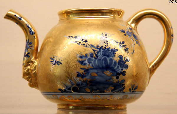 Meissen porcelain gold teapot (c1720s) painted with blue flowers at Meissen porcelain museum at Lustheim Palace. Munich, Germany.