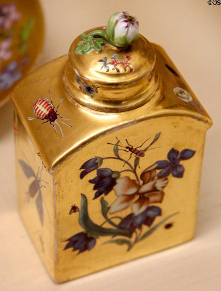 Meissen porcelain tea caddy (c1740) with gold background, tree flowers & insects at Meissen porcelain museum at Lustheim Palace. Munich, Germany.