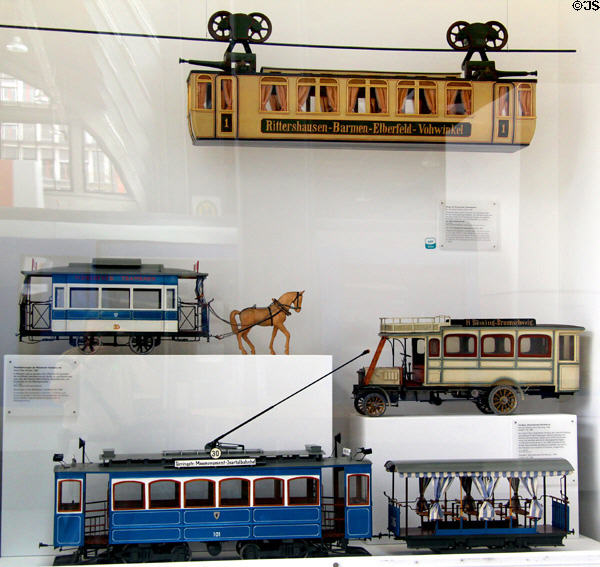 Models of Munich horse tram (1882), electric tram (1898) & omnibus (1904) under Wuppertal suspension railway car (1900) at Deutsches Museum Transport Museum. Munich, Germany.