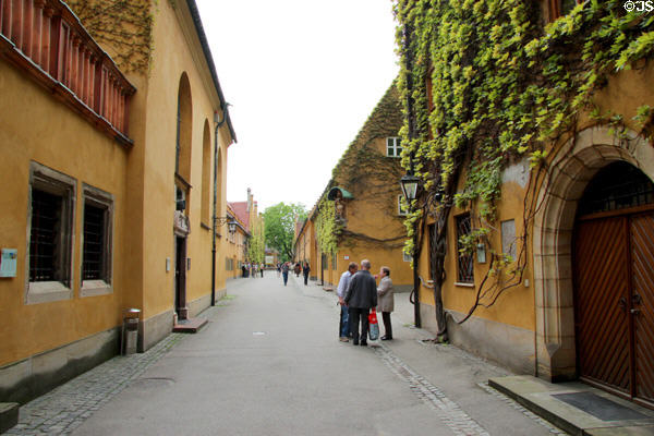 Street & ivy covered homes within walls of Fuggerei. Augsburg, Germany.