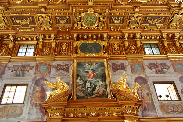 Ornate gilded ceiling & with mythological painting set into door pediment in Goldener Saal at Augsburg Rathaus. Augsburg, Germany.