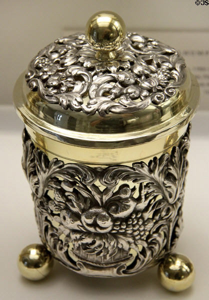 Ornately carved, lidded silver cup on "ball" feet with gold plated trim (1680-5) by goldsmith Adolf Gaap from Augsburg at Maximilian Museum. Augsburg, Germany.