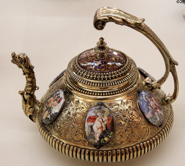 Ornate silver teapot with enameling on copper & adorned with six porcelain medallions depicting Greek Gods (c1705) by goldsmith Esaias II Busch & unknown enameller from Augsburg at Maximilian Museum. Augsburg, Germany.