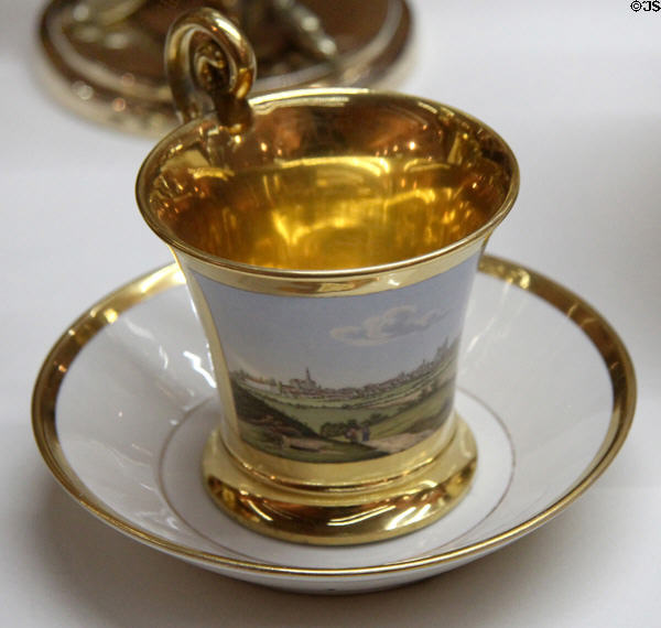 Cup & saucer with view of Augsburg & gold trim (c1830) made by Nymphenburg Porcelain of Munich at Maximilian Museum. Augsburg, Germany.