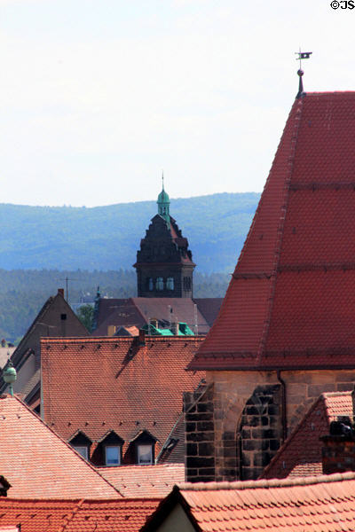 Spire of Higher Regional Court of Bamberg beyond church. Bamberg, Germany.
