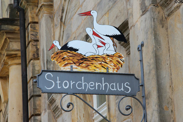 Shop sign painted with stork nest. Bayreuth, Germany.