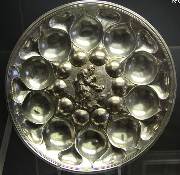 Silvered copper Alms bowl (1629) with relief of beggar holding a hat at Coburg Castle. Coburg, Germany.