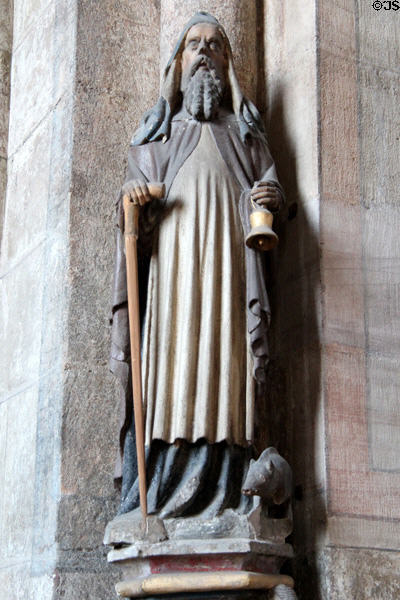 Carving of St Anthony the Great with pig, bell, & monk's habit symbols at St Sebaldus Church. Nuremberg, Germany.