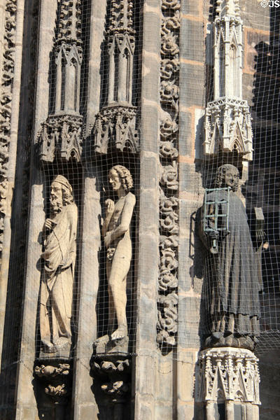 Adam & St Lawrence with grill beside door of St Lawrence Church. Nuremberg, Germany.