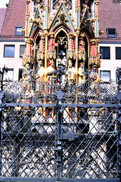Details of figures & wrought iron fencing of Schöner Brunnen (beautiful fountain) (14thC) on City Hall Market square. Nuremberg, Germany.