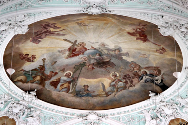 Baroque ceiling painting of holy trinity surrounded by saints in heaven at Gößweinstein pilgrimage basilica. Gößweinstein, Germany.