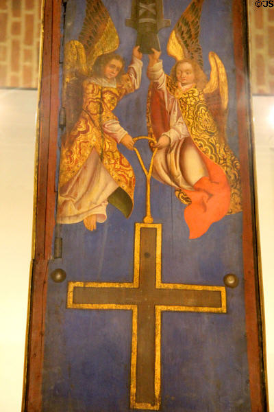 Painted panel with angels holding cross at Germanisches Nationalmuseum. Nuremberg, Germany.