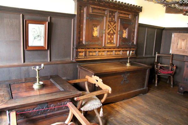 X-chair (aka Savonarola chair) beside carved table with cabinet & chest beyond at Albrecht Dürer's House. Nuremberg, Germany.