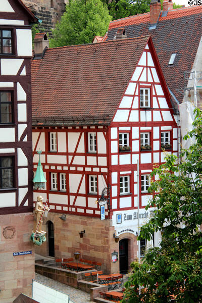 Buildings opposite Tiergärtnertorplatz from Albrecht Dürer's House with corner sculpture of St Michael slaying dragon. Nuremberg, Germany.