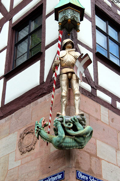 Sculpture of St. Michael slaying dragon on corner of building on Tiergärtnertorplatz. Nuremberg, Germany.