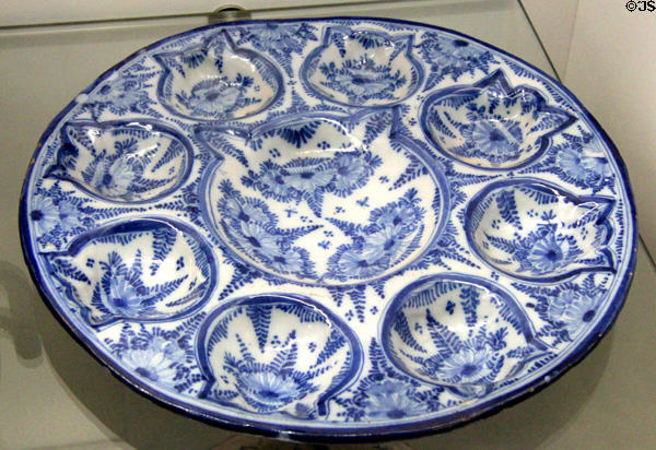 Blue-painted ceramic plate with mussel-shaped compartment (c1730-30) from Nuremberg at Fembohaus City Museum. Nuremberg, Germany.