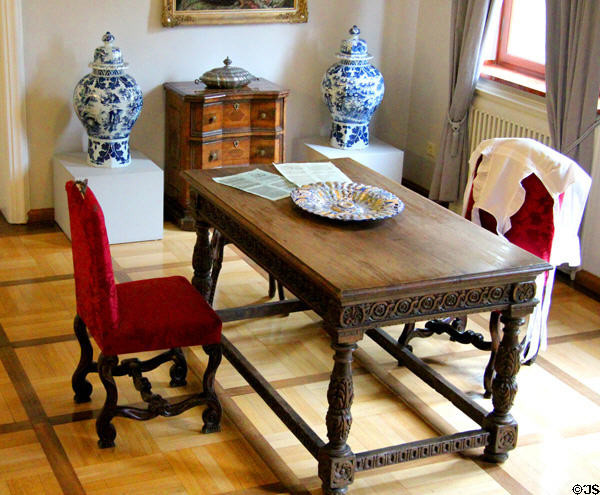 Table & chairs with cabinet & Chinese porcelain beyond at Tucher Mansion Museum. Nuremberg, Germany.
