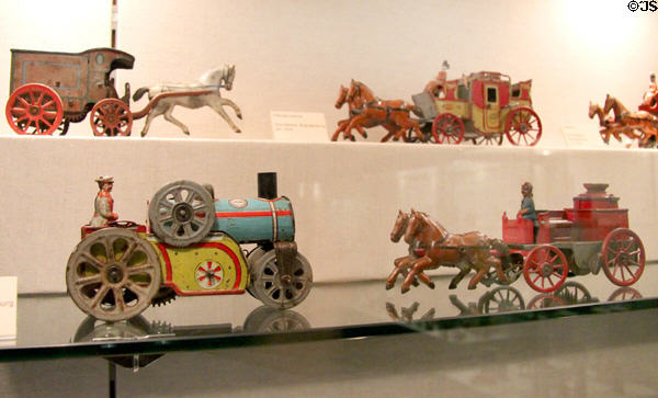 Wind-up horse-drawn carriages, steam roller & fire wagon (early 20thC) at City Toy Museum. Nuremberg, Germany.